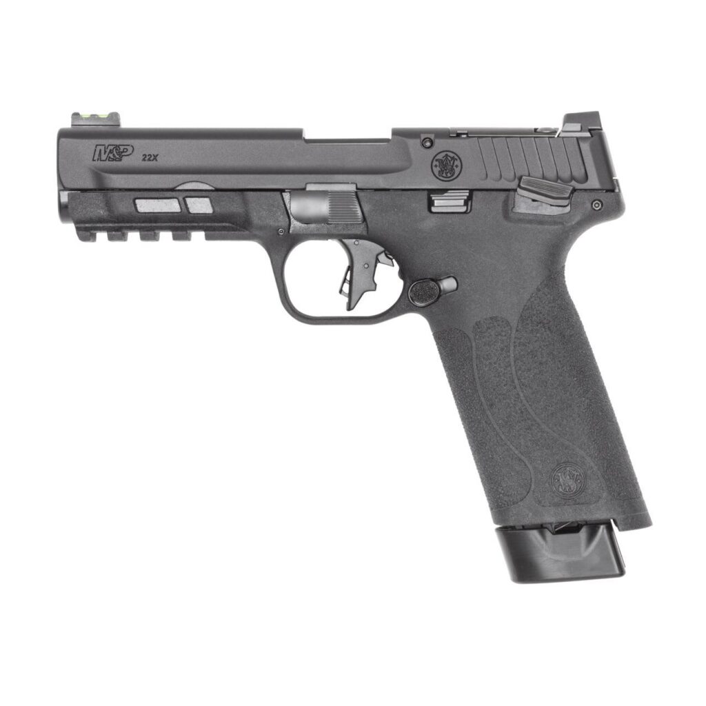 In-use photoreal 8K image of the black M&P 22X handgun with magazine inserted, slide locked back, on a wooden shooting bench with brass casings nearby